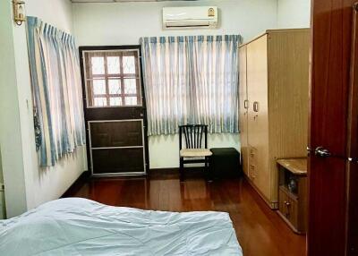 Bedroom with wooden floor and large wardrobe