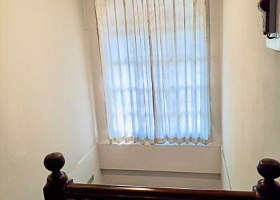 Staircase landing with window and railing