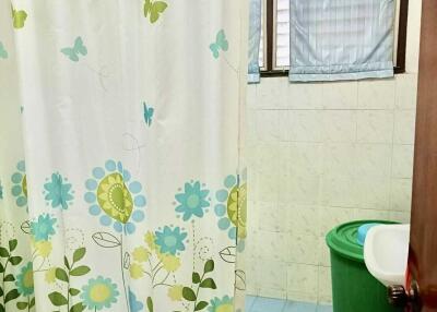 Bathroom with shower curtain and tiled walls