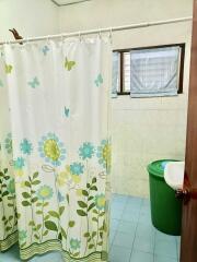 Bathroom with shower curtain and tiled walls