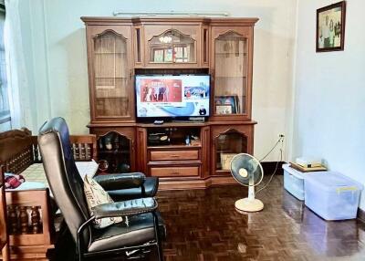 Living room with wooden furniture and television