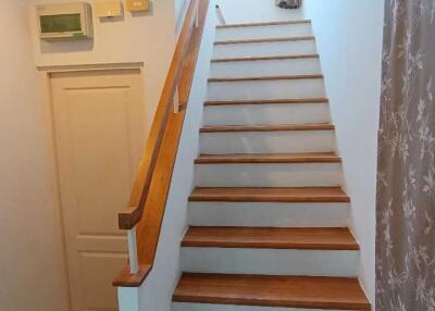 staircase leading to upper floor with wooden steps