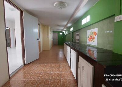 Spacious kitchen with tiled floor and ample countertop space