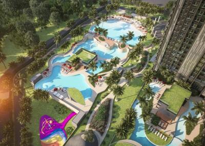 Aerial view of a luxurious outdoor swimming pool area with surrounding greenery and lounge areas