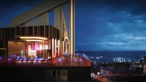 High-rise building with city and ocean view at night