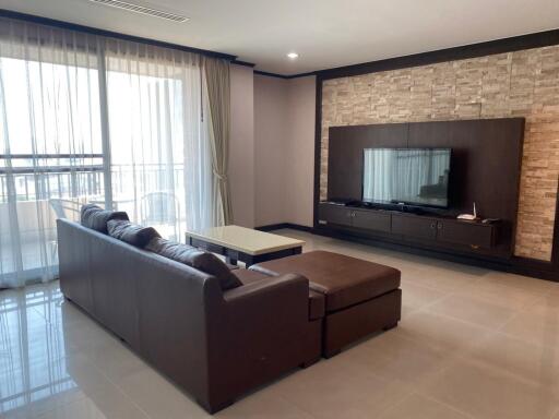 Modern living room with large sectional sofa and entertainment system