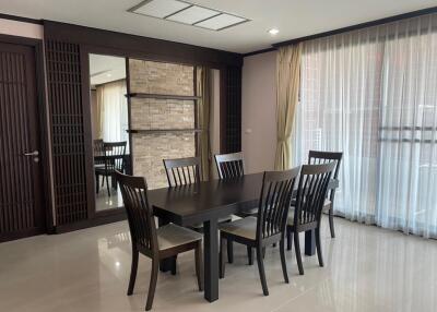 Modern dining room with dark wood furniture and large windows