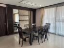 Modern dining room with dark wood furniture and large windows