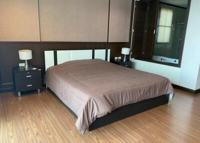 Modern bedroom with wooden flooring