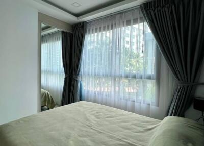 Bright and cozy bedroom with large windows and curtains
