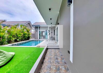 Home exterior with pool and lawn