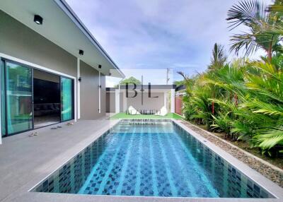 Swimming pool area with modern exterior and tropical landscaping