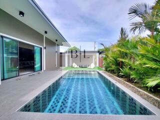 Swimming pool area with modern exterior and tropical landscaping