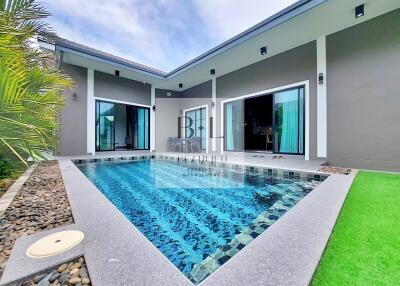Outdoor swimming pool with adjacent modern house