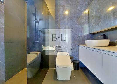 Modern bathroom with sleek design, floating vanity, and glass-enclosed shower