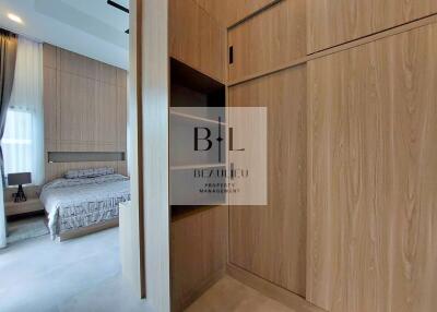 View of bedroom with built-in wooden closets