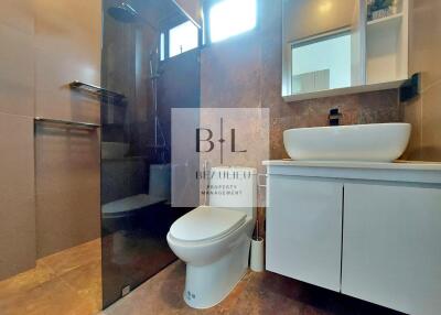 Modern bathroom with glass shower and white vanity