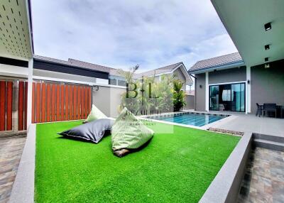 Outdoor space with pool and artificial lawn