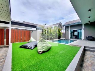 Outdoor space with pool and artificial lawn