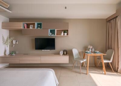 Modern living area with wall-mounted TV and dining table