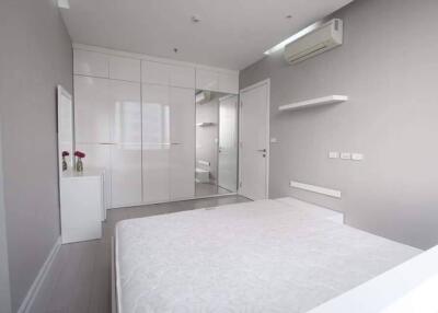 Modern white bedroom with wardrobe and air conditioner