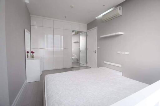 Modern white bedroom with wardrobe and air conditioner