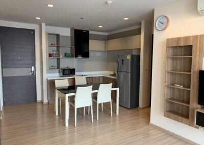 Modern kitchen and dining area with wooden flooring