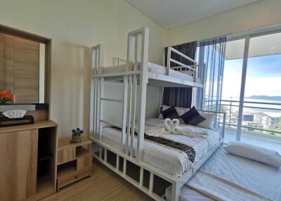 Bright bedroom with bunk beds and a balcony view