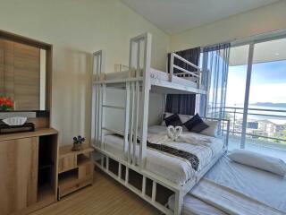 Bright bedroom with bunk beds and a balcony view