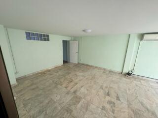 Spacious main living area with tiled floor and air conditioning