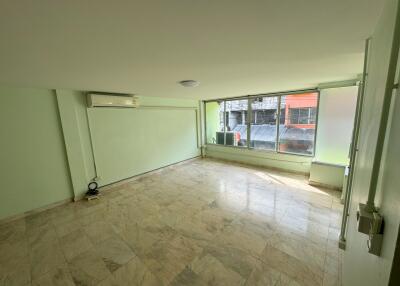 Spacious living room with large windows and air conditioning unit