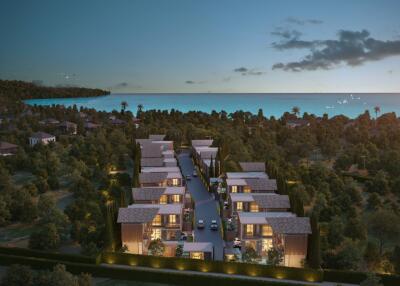 Aerial view of a modern housing community near the coast at dusk