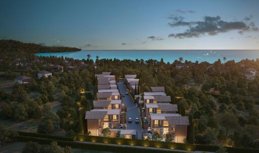 Aerial view of a modern housing community near the coast at dusk