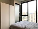 Modern bedroom with large windows and city view