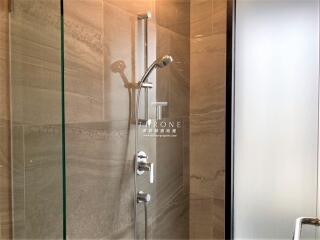 Modern shower in bathroom with glass door