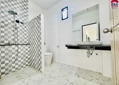 Modern bathroom with shower and tiled walls