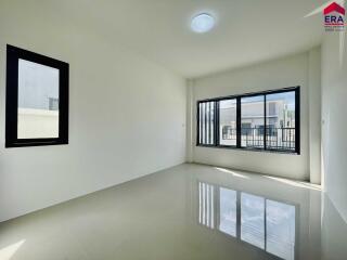 Spacious empty room with large windows and glossy floor