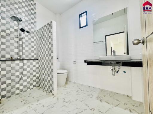 Modern bathroom with checkered tiles and glass shower partition