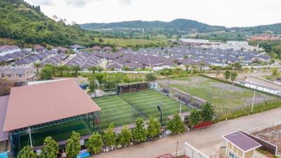 Aerial view of residential community with sports facilities