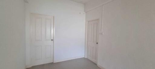 Small room with two doors and simple white walls