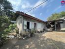 Exterior view of a small building with a tin roof