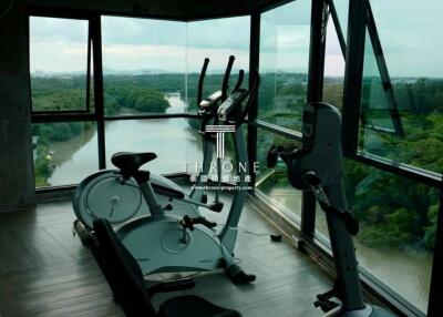 Home exercise room with cardio equipment and scenic view