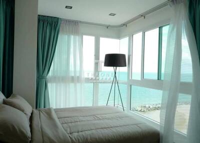 Bright bedroom with large windows overlooking the sea