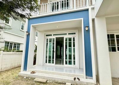 Two-story house front view with patio and balcony