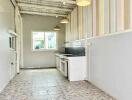 Spacious kitchen with striped walls and tiled flooring