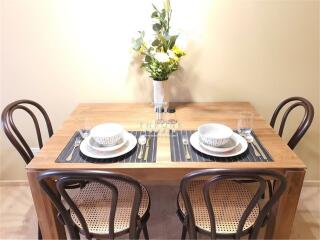 Dining area with wooden table set for two