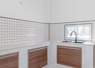 Modern kitchen with tiled backsplash and wooden cabinets