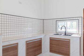 Modern kitchen with tiled backsplash and wooden cabinets