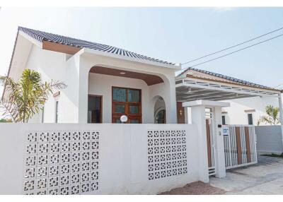 Modern house exterior with white wall and gate