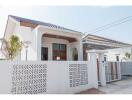 Modern house exterior with white wall and gate